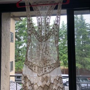 Cream colored lace racer back tank top.